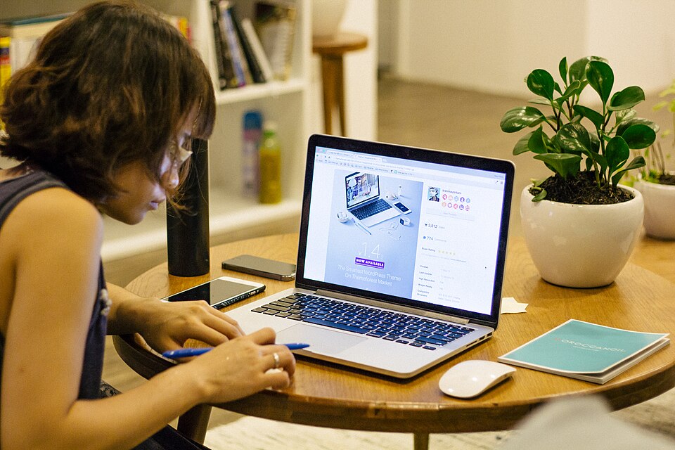 Freelancer working on a laptop at a café table