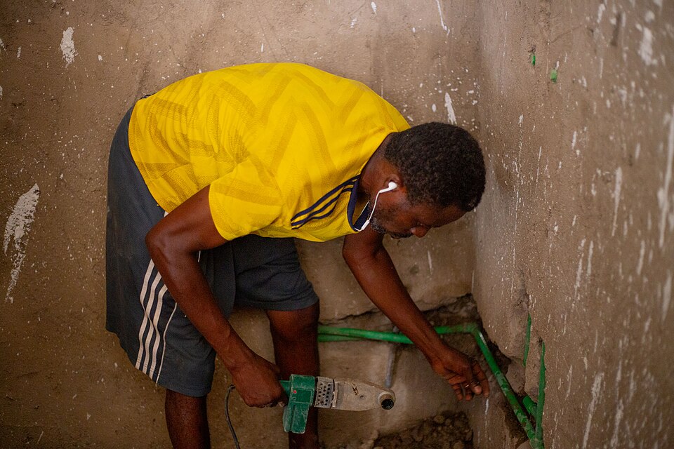 Plumber joining pipework on a job site